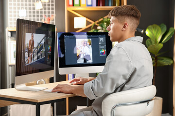 Fototapeta premium Professional retoucher editing photo on computer at table in office