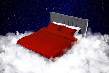 Large bed on fluffy clouds in starry night sky