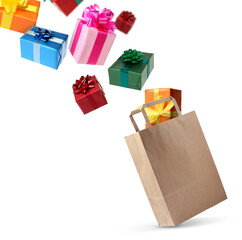 Many gift boxes falling into paper bag on white background