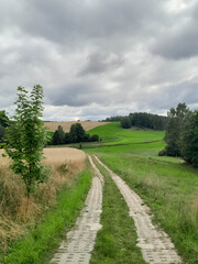 Dark clouds over meadow in Kashubia. Rainy weather coming.