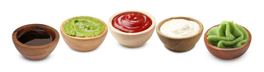 Wasabi and other condiments in bowls isolated on white, set