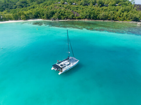 Catamaran anchored in turquoise waters at Port Launay Seychelles
