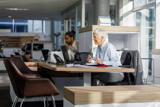 Businesswoman doing video call through laptop at desk in office