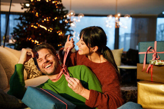 Couple enjoying Christmas together with gifts and joyful affection