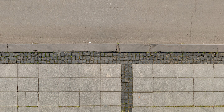 top view of the texture sidewalk or road paved with large stones or cobblestones on pedestrian path