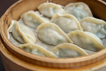 Steamed dumplings in bamboo steamer.