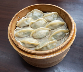 Steamed dumplings in bamboo steamer.