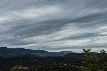 landscape with hills under a dark clouded sky in the French region of the Verdon