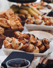 Set of coffee break in the hotel during conference meeting, with tea and coffee catering, decorated catering banquet table with variety of different pastry and bakery, with croissants, pie and cookies