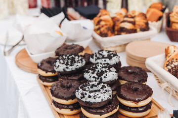 Set of coffee break in the hotel during conference meeting, with tea and coffee catering, decorated catering banquet table with variety of different pastry and bakery, with croissants, pie and cookies
