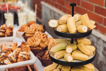 Set of coffee break in the hotel during conference meeting, with tea and coffee catering, decorated catering banquet table with variety of different pastry and bakery, with croissants, pie and cookies