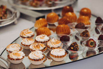 Set of coffee break in the hotel during conference meeting, with tea and coffee catering, decorated catering banquet table with variety of different pastry and bakery, with croissants, pie and cookies