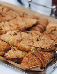 Set of coffee break in the hotel during conference meeting, with tea and coffee catering, decorated catering banquet table with variety of different pastry and bakery, with croissants, pie and cookies