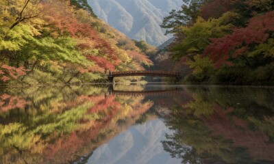 Scenic landscape wooden bridge spans reflective lake, framed by autumn foliage and misty mountains