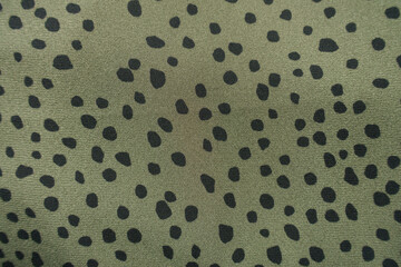 olive green and black spotted fabric from above