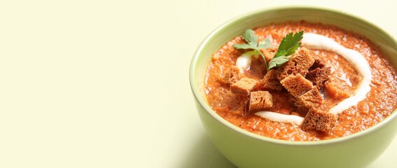 Bowl of tasty cream soup on light background with space for text, closeup