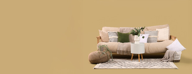 Beige sofa with table, pouf and carpet on green background