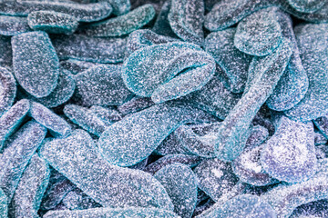 Sweet and tangy blue fruit gummies with sugar coating