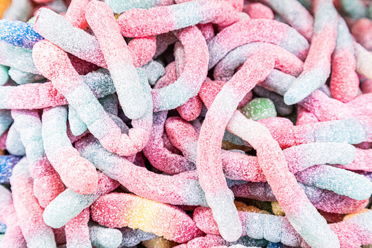 Assorted colorful gummy worms with sugar coating