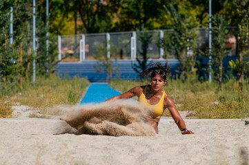Athlete competing in long jump on sunny day
