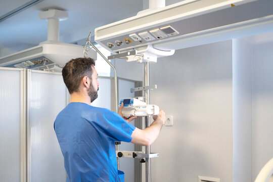 Nursing assistant managing equipment in the ICU