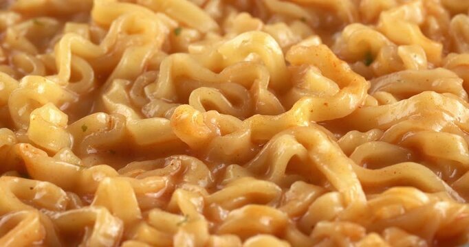 Korean spicy noodle soup ramyeon. Hot instant noodles. Close-up footage on the rotating table.