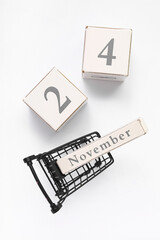 Shopping cart with date NOVEMBER 24 on white background. Black Friday sale
