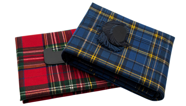 Two traditional tartan kilts showcasing vibrant Scottish patterns isolated on transparent background.
