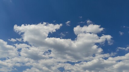 White and Gray Cumulus Clouds on a Deep Blue Sky.