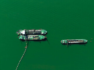 Plain teal green background of dredgers working.