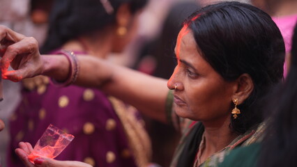Woman celebrating Chhath Puja by applying sindoor after completing morning prayer, showing devotion, purity, and traditional Indian culture.