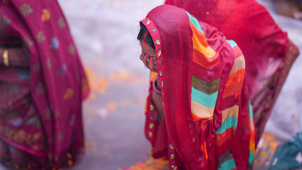 Indian woman standing in sacred water during Chhath Puja