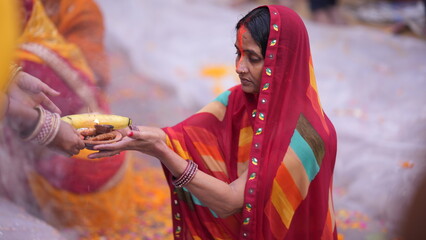 Woman immersed in sacred water during Chhath Puja, offering Arghya to the rising Sun with devotion and spiritual grace.