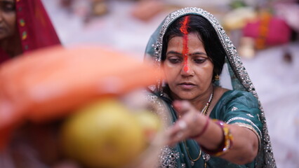 Indian woman offering Arghya to Chhathi Maiya during Chhath Puja sunrise prayer, showing faith and inner devotion.