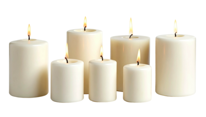 Group of seven lit, white cylindrical wax candles, black backdrop