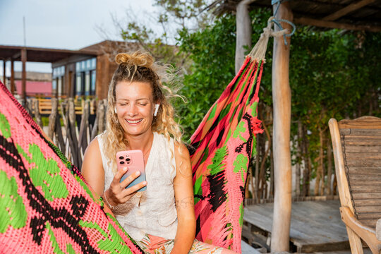 Businesswoman working remotely in a hammock in Colombia