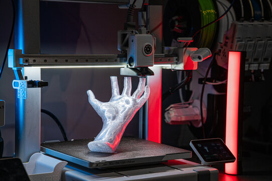3D printer creating prosthetic hand prototype