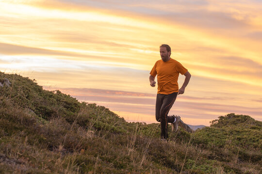 Man running at sunset in the Pyrenees landscape