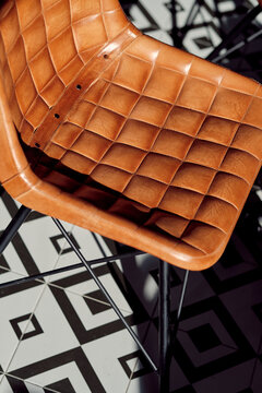 Elegant leather chair and patterned floor in restaurant