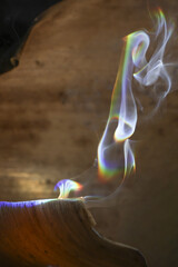 Serene, spiritual plume of colorful abstract smoke rises with mesmerizing rainbow light effect....