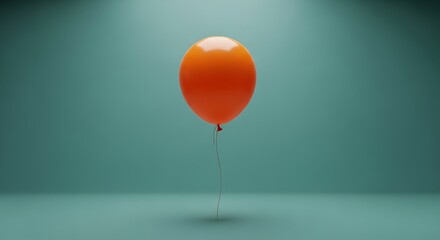 Single bright orange inflated orb hangs suspended by a thin string against a muted teal  background