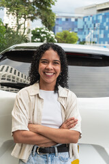 Young woman smiling confident standing by car