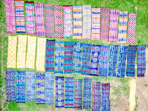 Aerial view of vibrant textiles laid out on the ground in a dazzling display of color and pattern, Ede, Osun, Nigeria.