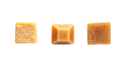 Three golden bouillon cubes isolated on transparent background