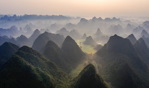 Aerial view of jagged peaks rise through the mist, a landscape sculpted by time and nature's artistry, Cao Bang, Cao Bang, Vietnam.