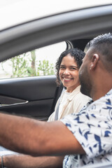 Happy couple enjoying road trip, smiling inside car