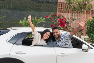 Happy couple enjoying car road trip vacation