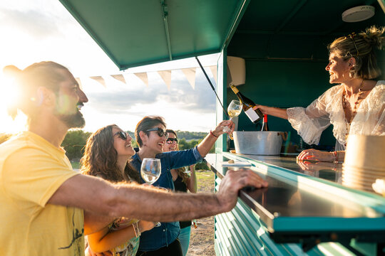 Friends enjoying wine at outdoor food truck party