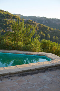 Serene rural poolside with lush green hills