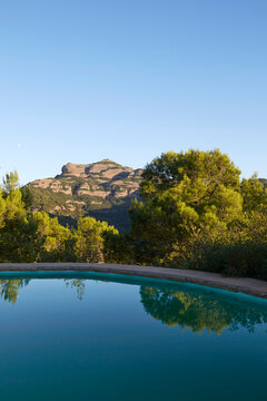 Mountain view over a serene forest and pool